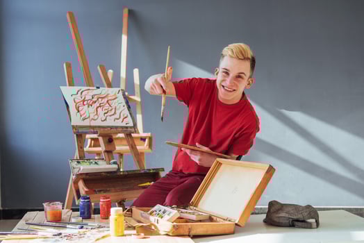 artist painting a picture in a studio photo