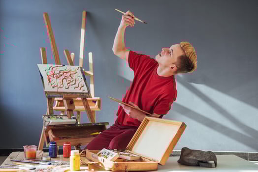 artist painting a picture in a studio photo