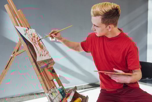 artist painting a picture in a studio photo