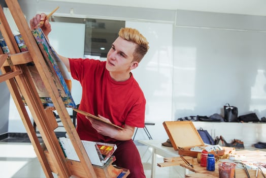 artist painting a picture in a studio photo