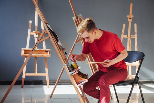 artist painting a picture in a studio photo