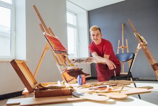 artist painting a picture in a studio photo