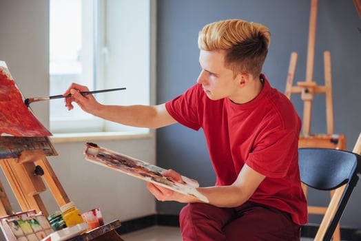 artist painting a picture in a studio photo