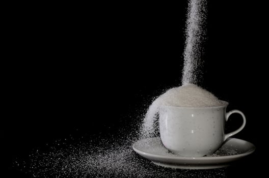 cup with sugar goes on photo