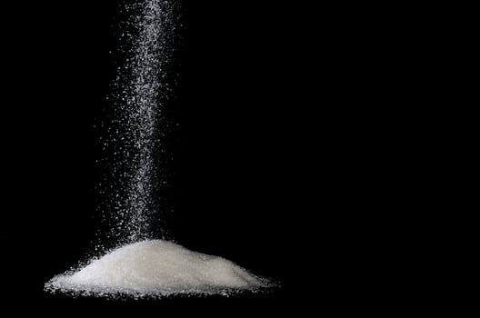 sugar sprinkle with black background photo