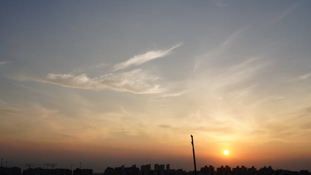 The beautiful sunset view with the silhouette and colorful clouds sky in the city photo