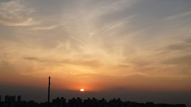 The beautiful sunset view with the silhouette and colorful clouds sky in the city photo