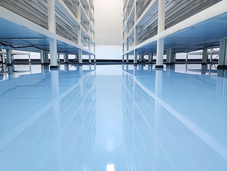a cable under rack legs at sea blue epoxy floor.Industrial epoxy floor photo