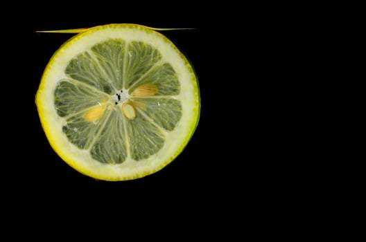 fresh lemon in water black photo