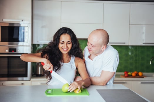 woman cuts vegetables together in the kitchen. photo