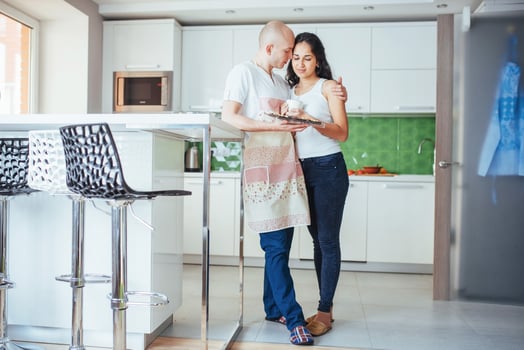 Happy young couple having coffee in the kitchen photo