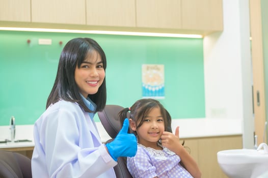 A little cute girl having teeth examined by dentist in dental clinic, teeth check-up and Healthy teeth concept photo