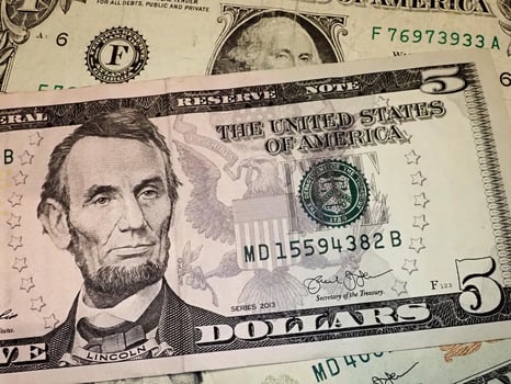 Abraham Abe Lincoln face portrait on 5 dollar bill macro. United states money. photo