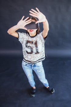 Happy woman gets experience of using VR-glasses virtual reality headset. photo