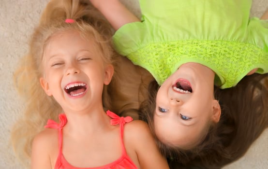 Happy little girls lying on their back. Top view. photo