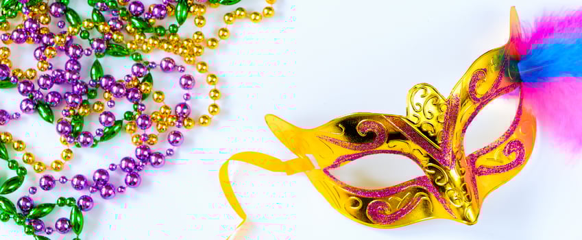 Carnival mask with feathers and colorful beads on white background. Mardi Gras or Fat Tuesday symbol. photo