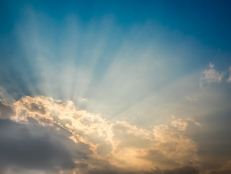 Sunbeam of the sun behind the clouds photo