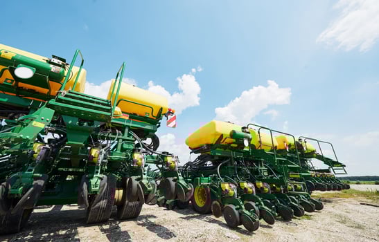 Close up of seeder attached to tractor in field. Agricultural machinery for spring works sowing photo