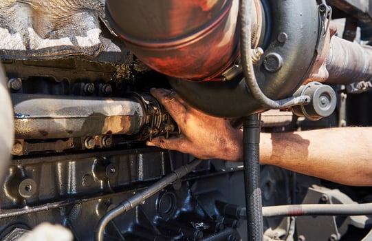 Combine machine service, mechanic repairing motor outdoors photo