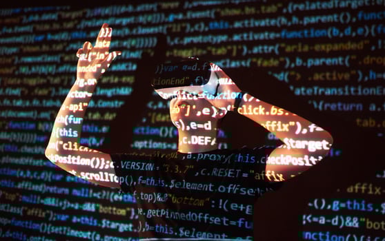 Double exposure of a caucasian man and Virtual reality headset is presumably a gamer or a hacker cracking the code into a secure network or server, with lines of code photo