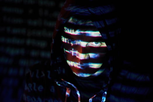Cyber attack with unrecognizable hooded hacker using virtual reality, digital glitch effect photo