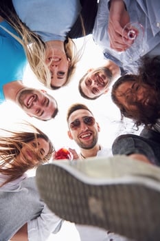 summer vacation, happy people - a group of teenagers looking down with a happy smile on his face. photo