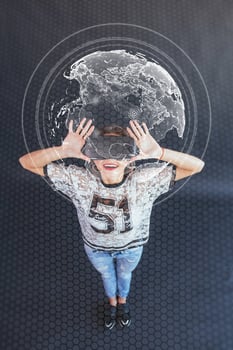 Young beautiful girl gets positive emotions using virtual reality goggles. The woman plays a game using augmented reality. Virtual world map photo