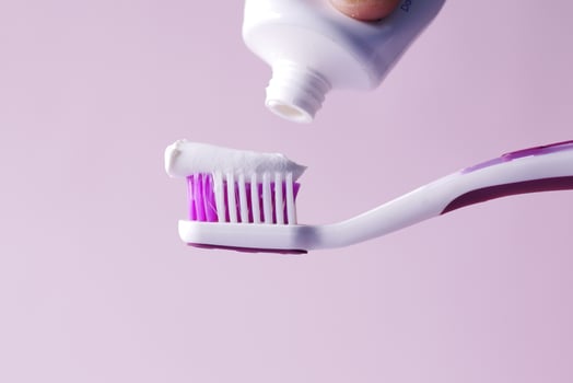 hand holding tooth brush with paste photo