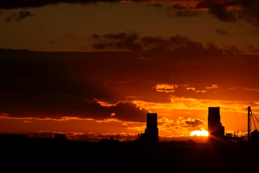 Sunset behind two Saskatchewan grain elevators photo
