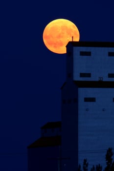 Full moon behind Tuxford grain elevator photo