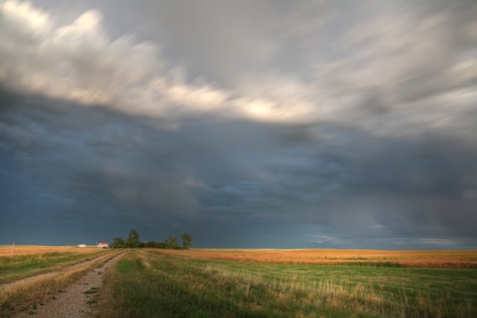 Storm clouds along a Saskatchewan farm road photo