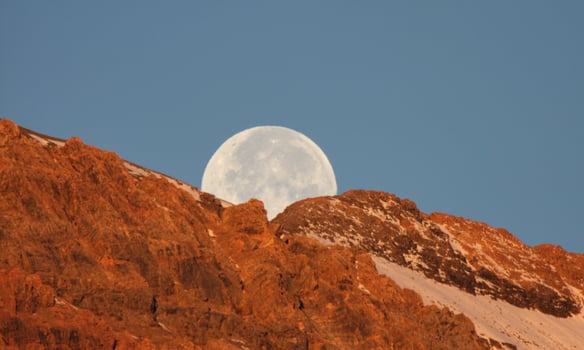 Full moon behind mountain in scenic Alberta photo
