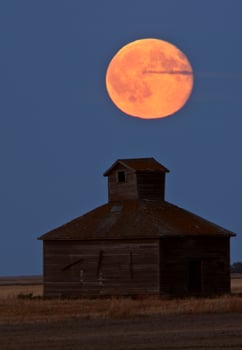 Full moon over old Saskatchewan barn photo