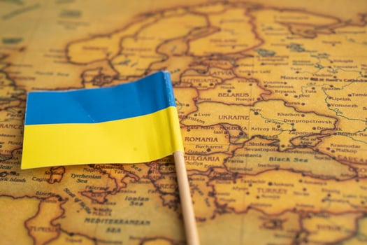 Bangkok, Thailand - February 1, 2022 Ukraine flag on vintage world map background. photo