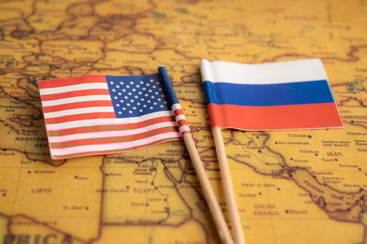 Bangkok, Thailand - February 1, 2022 Russia and USA America flag on vintage world map background. photo