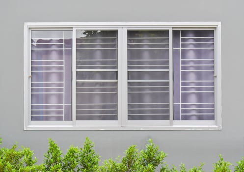 Modern windows with uv curtain and grey house wall from outside view photo