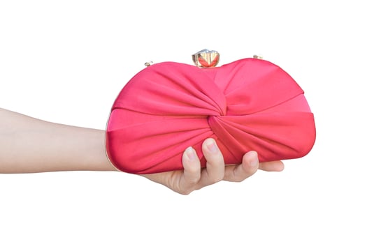 hand holding red luxury clutch bag isolated on white background. object with clipping path. photo