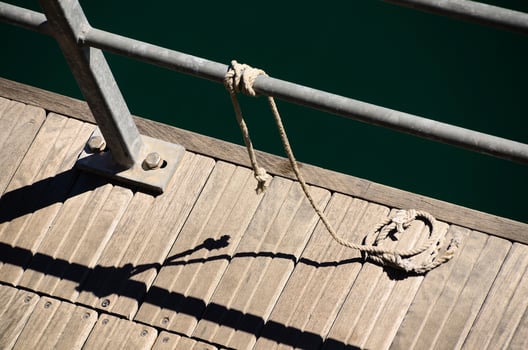 boardwalk with rope and shadow photo