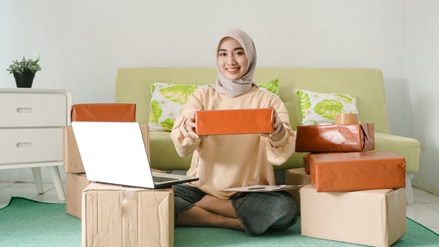 beautiful asian businessman showing ready-to-ship products photo