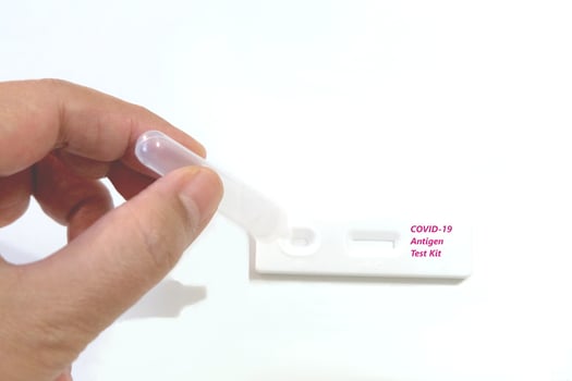 Self Coronavirus Self nasal or Home test by rapid antigen test kit. Hand hold sample solution in reagent tube. Drop the solution into test kit. photo