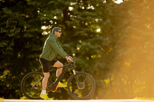 Young man riding ebike in nature photo