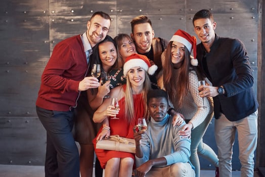 New Year is coming. Group of cheerful young multiethnic people in Santa hats on the party, posing emotional lifestyle people concept photo