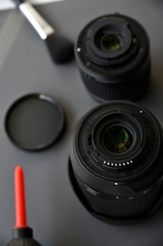 Cleaning photo lenses with a brush and a pear
