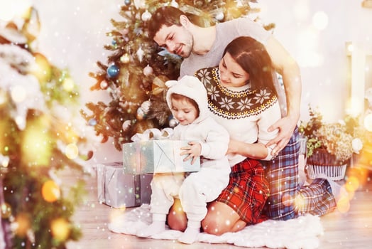Happy family at christmas in morning opening gifts together near the fir tree. The concept of family happiness and well-being photo