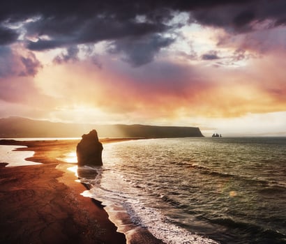 The black sand beach and mountains Reynisfjara from Cape at sunset in Iceland photo