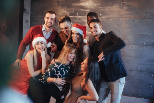 New Year is coming. Group of cheerful young multiethnic people in Santa hats on the party, posing emotional lifestyle people concept photo