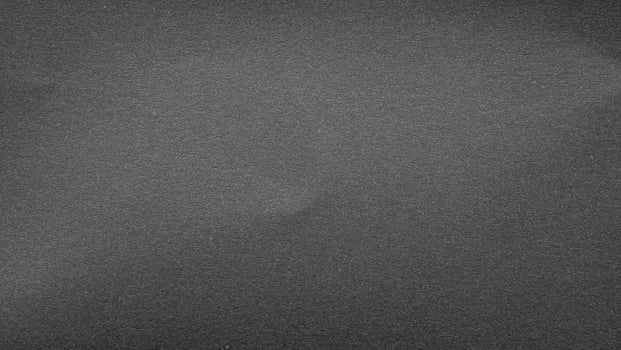 texture of black matte paper grainy gray effect canvas. seamless texture grainy noise effect on dark gray photo