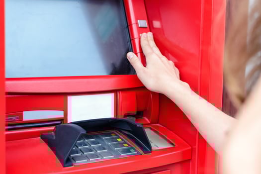 Young woman making payment at ATM photo