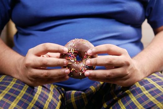 young man eating donut , selective focus photo