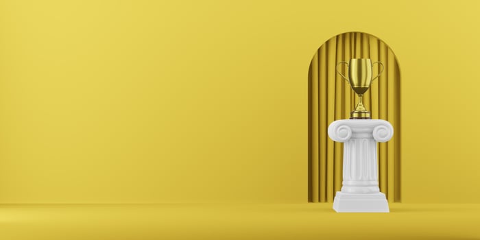 Abstract podium column with a golden trophy on the yellow background with arch. The victory pedestal is a minimalist concept. 3D rendering. photo